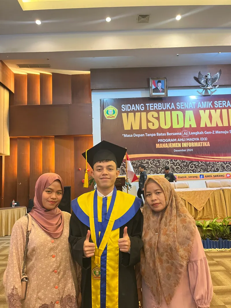 Rizki's graduation portrait with his mother and sister