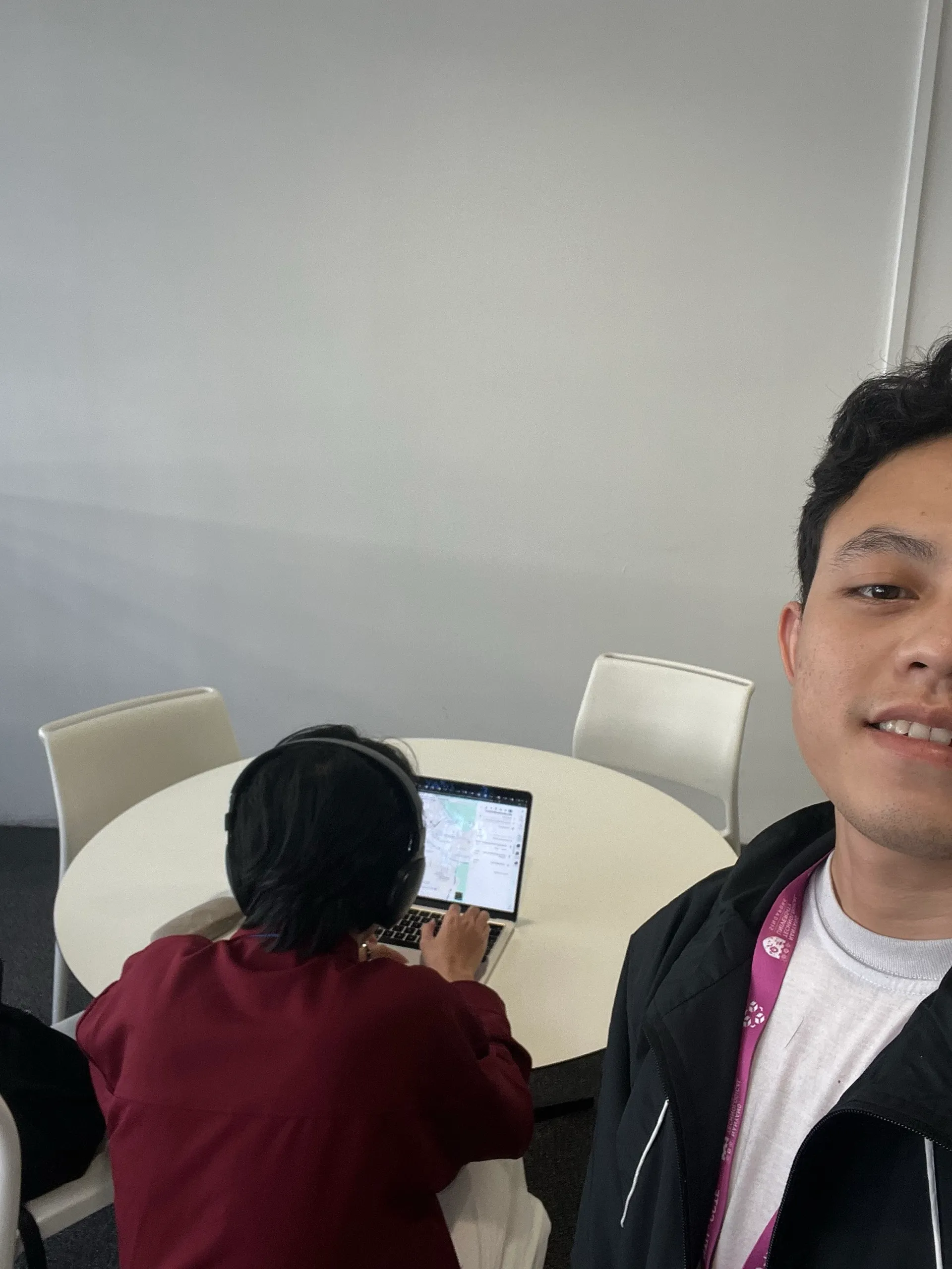 Me and Rizky working at a round table in Room B2 of the ARC