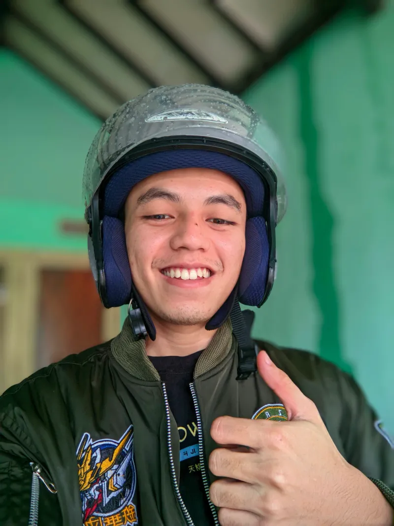 Rizki's selfie, jacket still wet after the rain